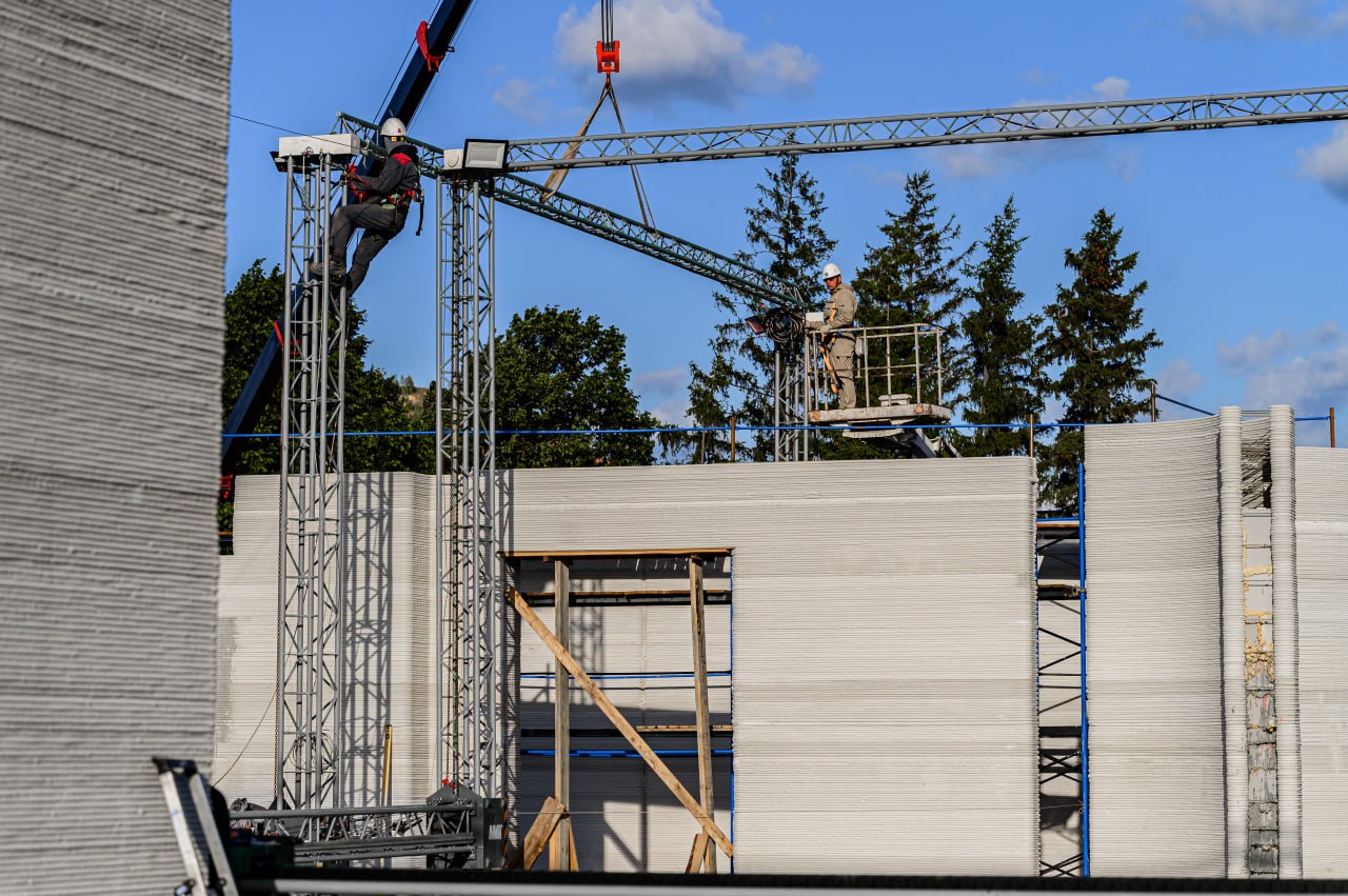 Completed 3D-printed building structure with layered concrete walls