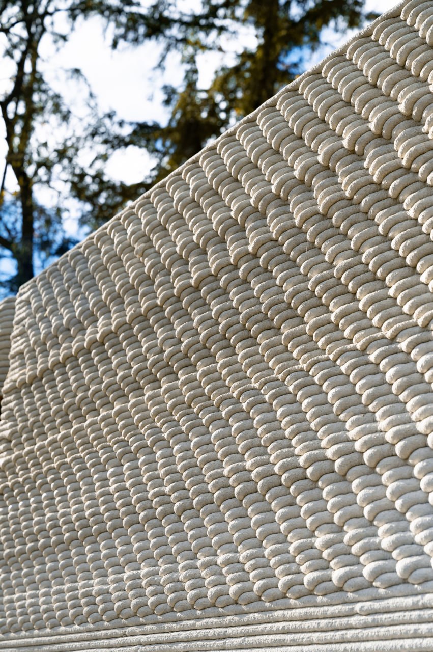 Close-up of 3D-printed concrete wall layers outdoors